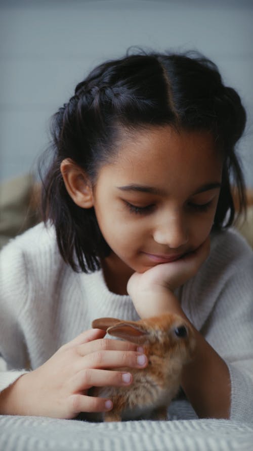 A Girl Petting Her Dwarf Rabbit