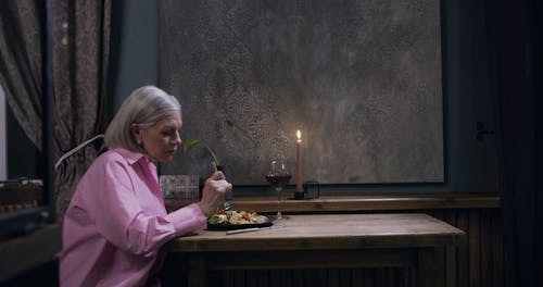 An Elderly Woman Having Dinner Alone