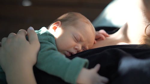 Baby Sleeping On Mother's Chest