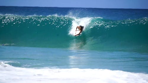 Young Man Surfing Waves