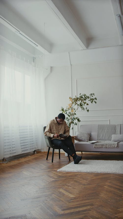 A Man Sitting while Reading a Book