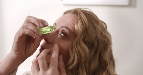 A Woman Using eye Drops