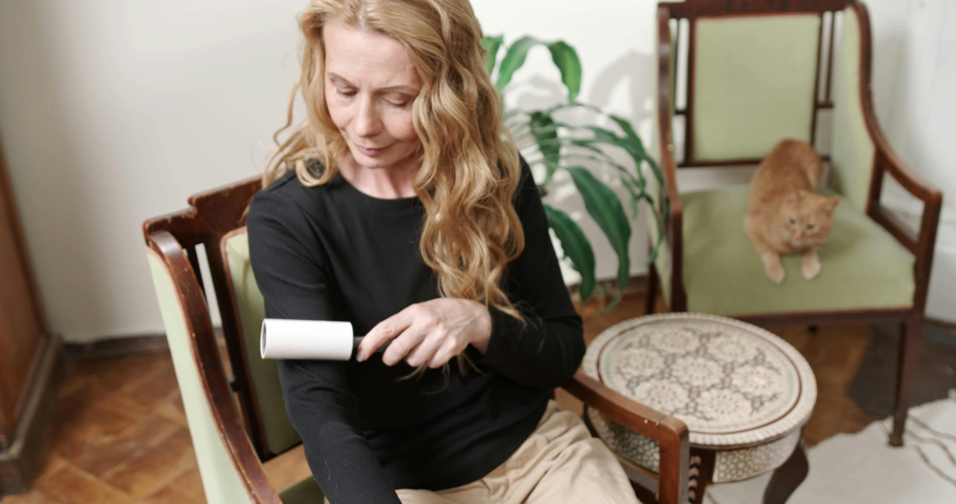 A woman removing lint on her clothes free stock video
