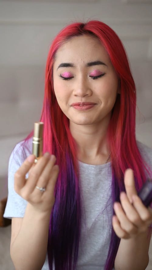 Woman Applying Red Lipstick