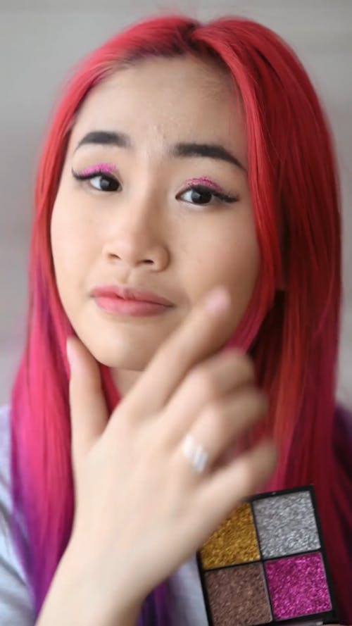 A Woman Applying Eyeshadow Using Her Fingers