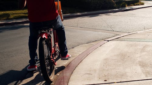 Man Riding a Bike to Deliver Mail