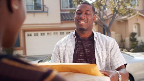 Man Delivering Packages To A Woman