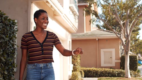 A Woman Receiving Her Packages From a Delivery Man