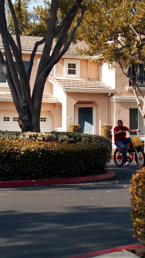 Delivery Man Riding a Bicycle and Raising Hand 