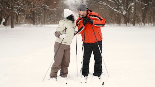 Affectionate Couple of Skiers Kissing Outdoors