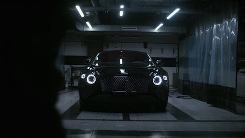 Woman Cleaning a Black Car