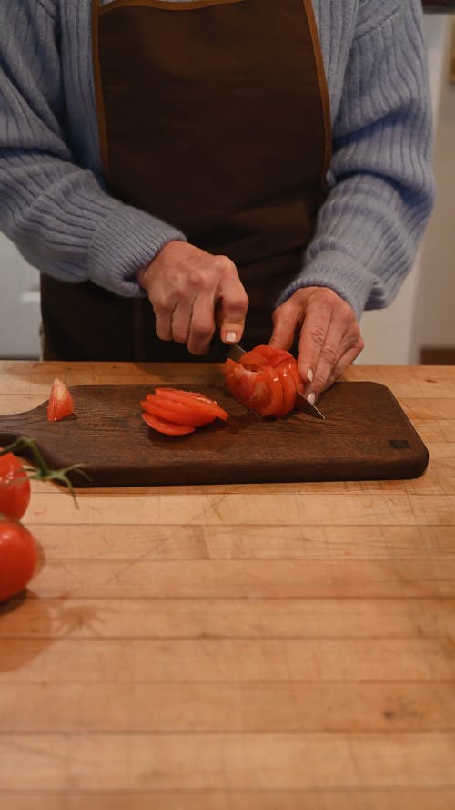 Person Slicing Fresh Tomato