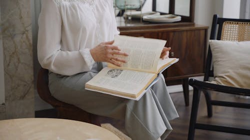 Woman Flipping through Pages of a Book