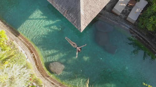 Woman Floating in the Pool