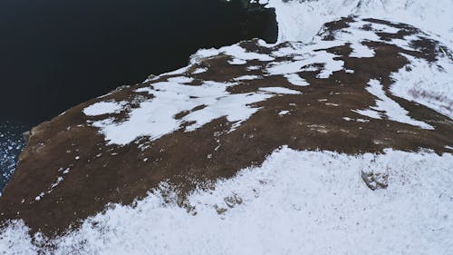 A Footage of a Snow Covered Cliff