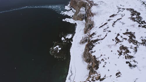 A Footage of a Snow Covered Cliff