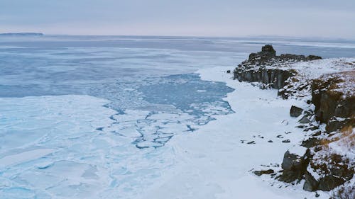 A Footage of a Snow Covered Cliff