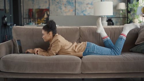 Woman Using Her Laptop on the Couch