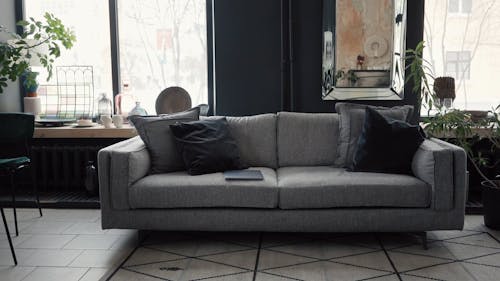 Woman Sitting on the Couch Using Laptop