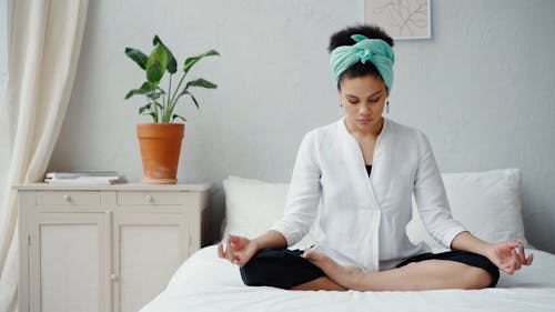 Woman Meditating on Her Bedroom