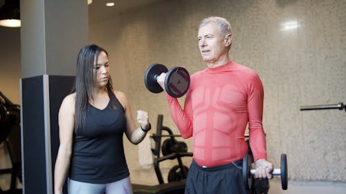 Elderly Man Doing Exercise at the Gym