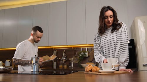 A Couple Having Coffee at the Kitchen