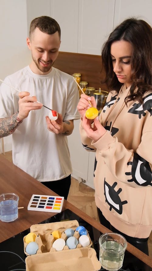 A Man and a Woman Painting Easter Eggs