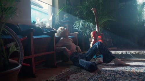 A Woman with Bleached Hair Resting Her Head on the Sofa