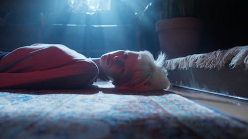 A Woman with Bleached Hair Lying on the Floor