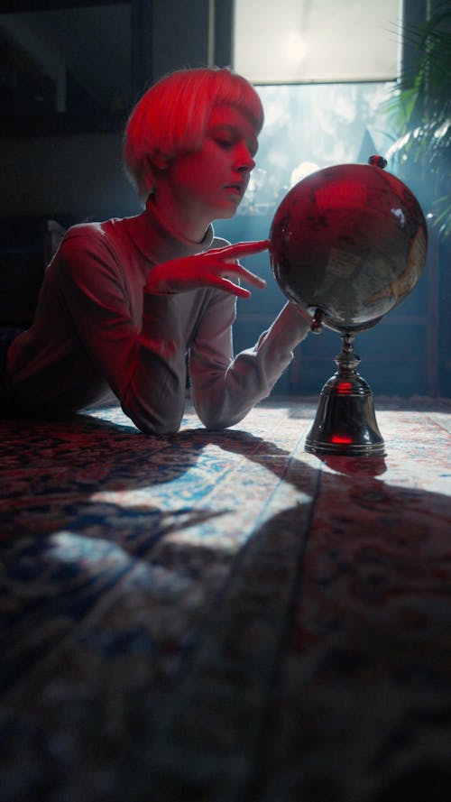 A Woman Spinning a Globe