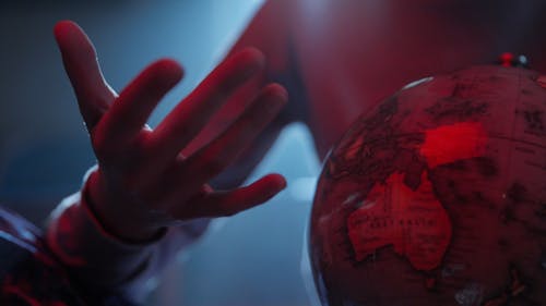 A Person Touching a Globe