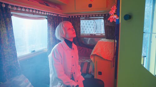 Pensive Blonde Girl Inside a Van