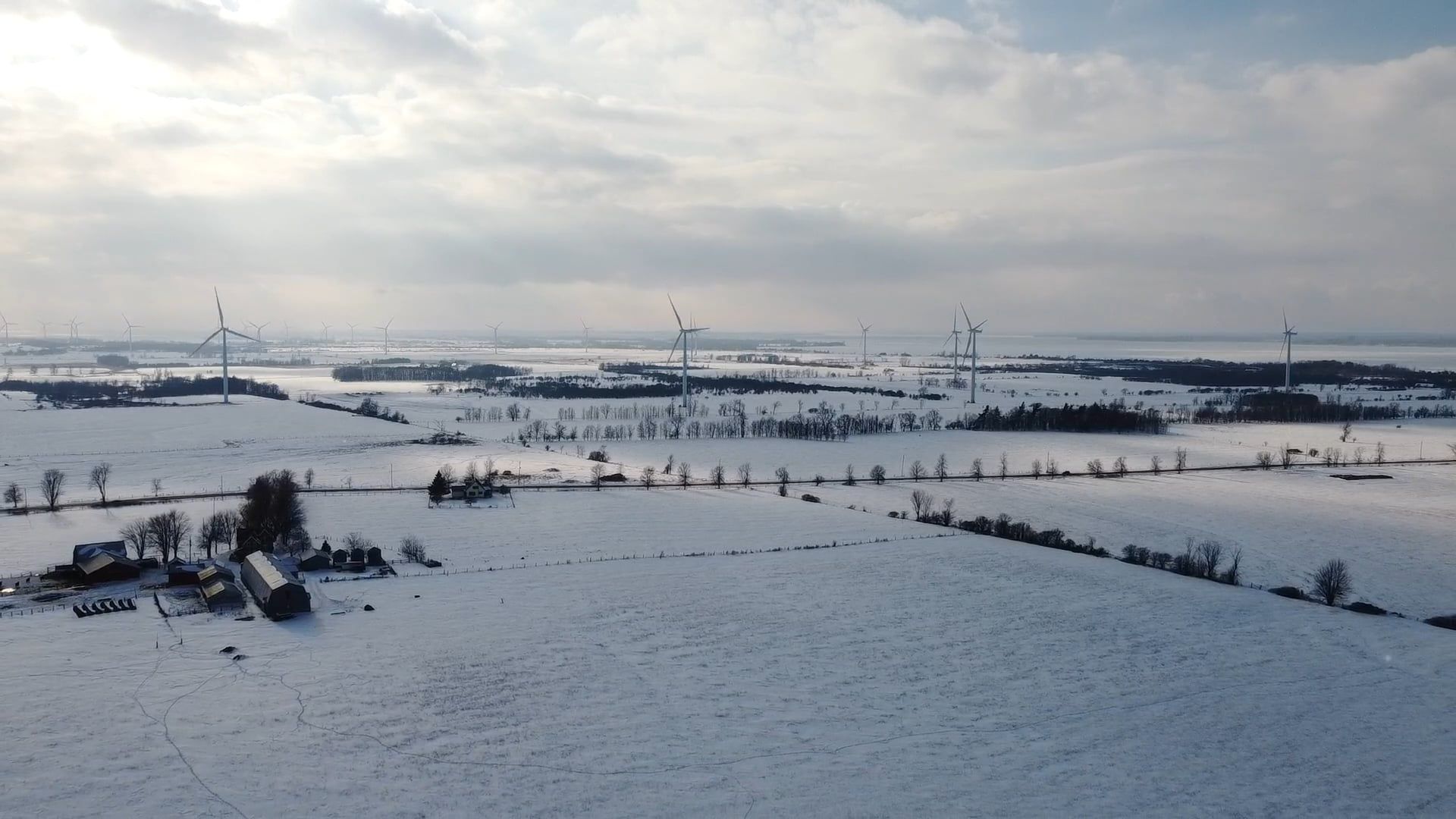 An Aerial Footage of a Snowy Field with Windmills Free Stock Video ...