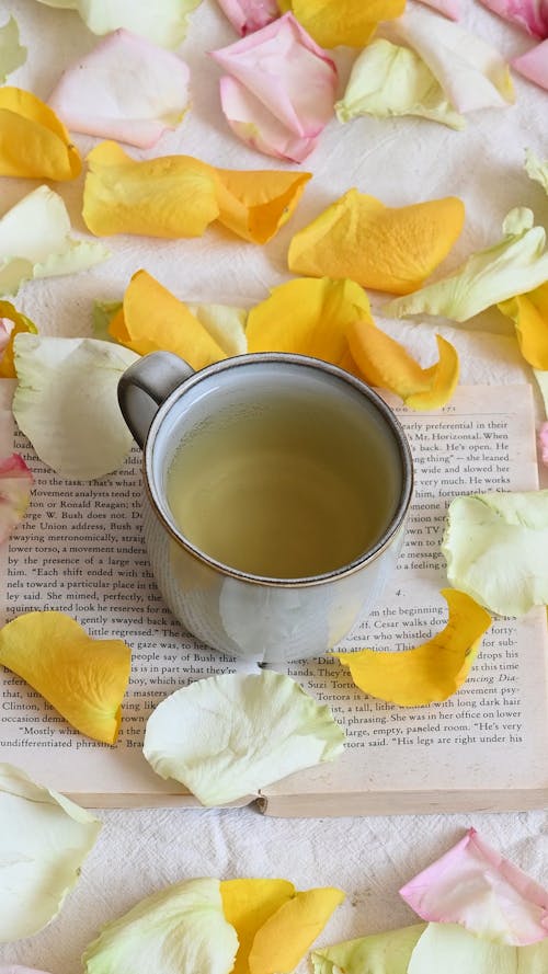 Person Putting Flower in a Tea