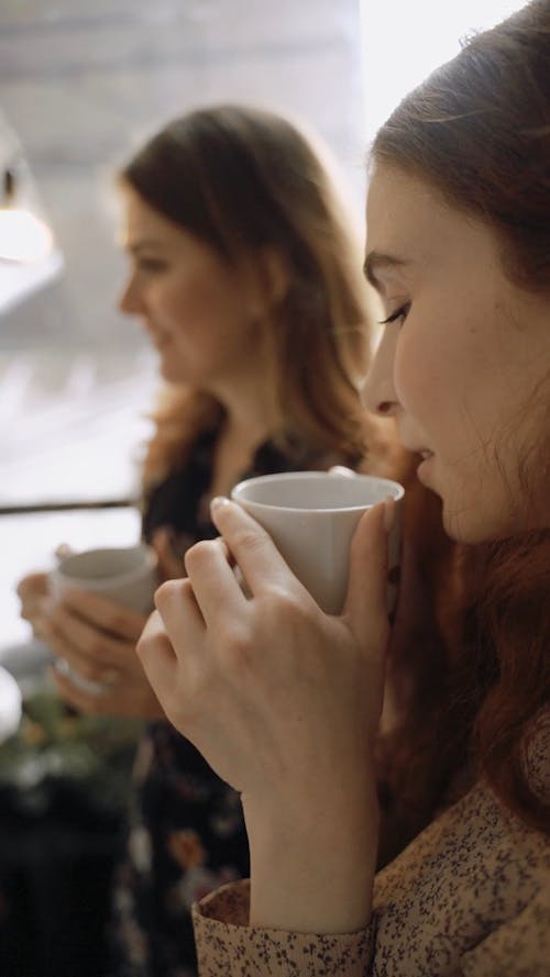 Women Drinking Hot Coffee while Talking