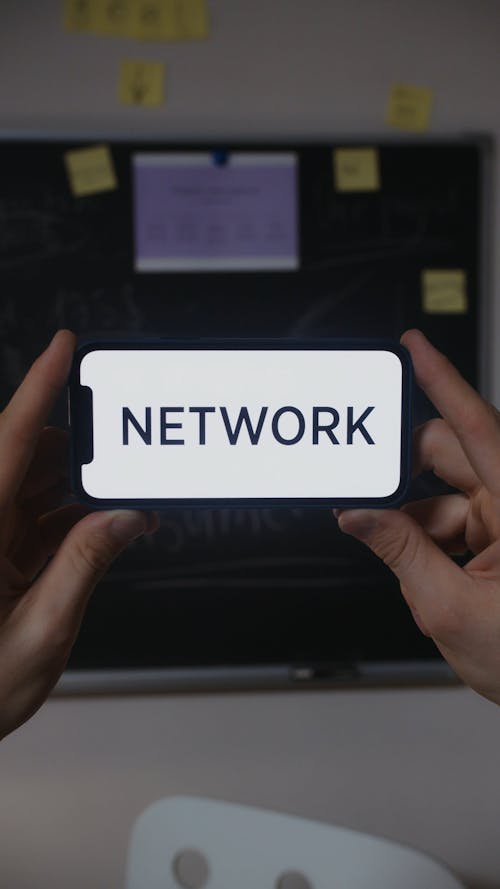 Close up of a Cellphone with the Word Network on the Screen