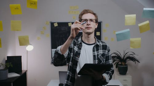 Man Writing Startup Ideas on Glass Wall