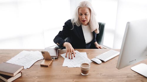 Elderly Woman Calculating Expenses