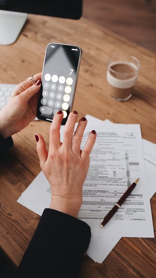 A Person Calculating Using a Smart Phone