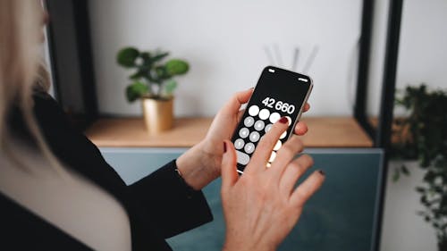 A Person Calculating Using a Smartphone