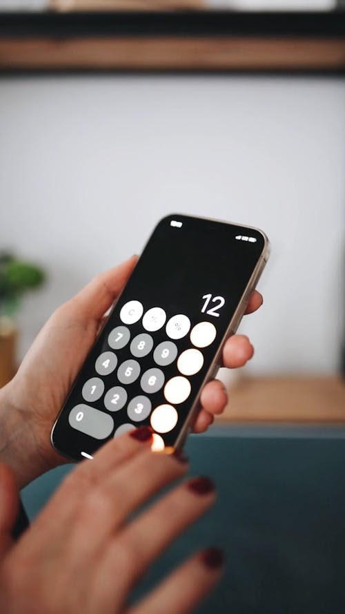 A Person Calculating Using a Smartphone