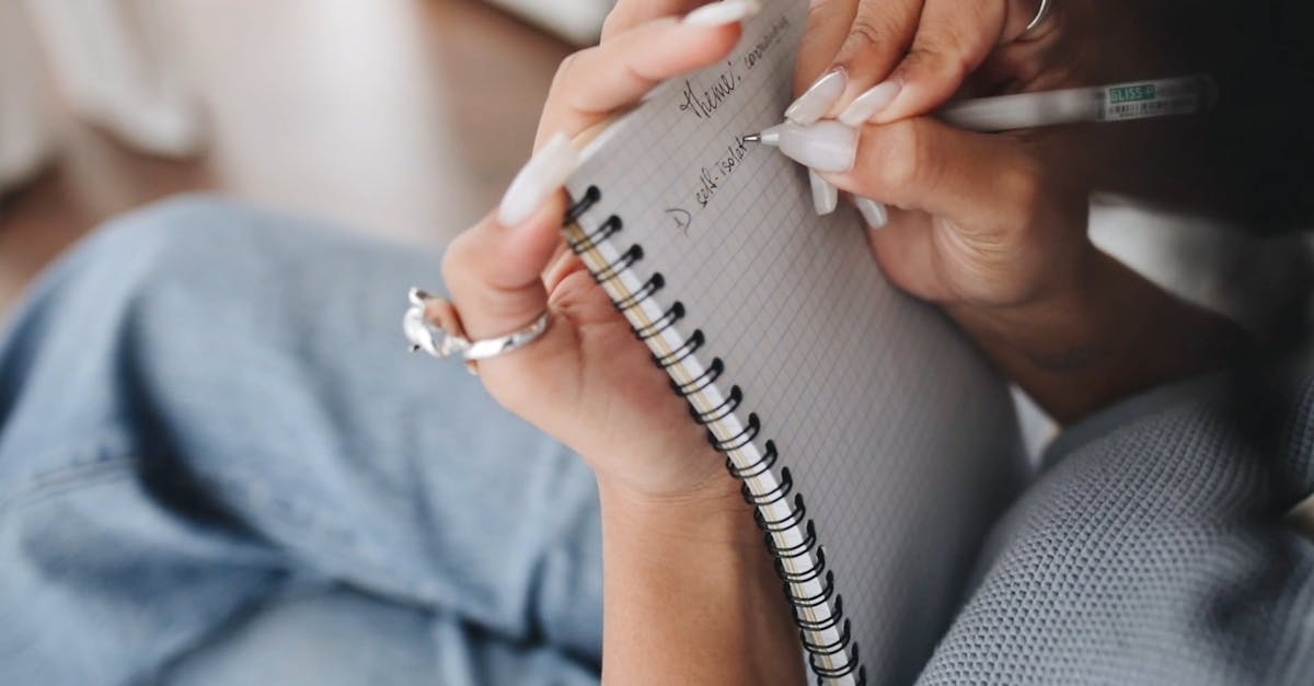 Close-Up View of a Person Writing Notes on Her Notebook Free Stock ...