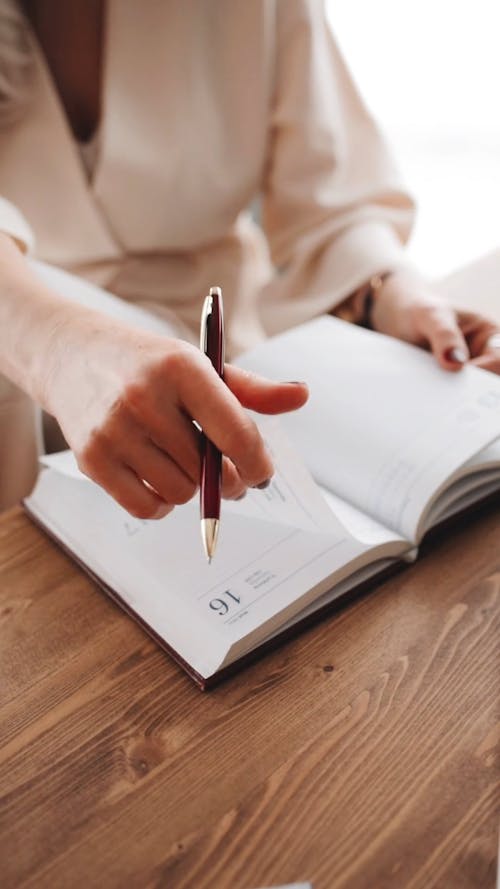 Person Browsing Through a Diary