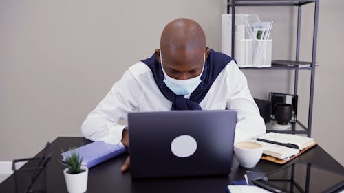 Man Typing on his Laptop