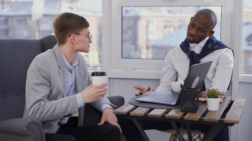 Men Talking while Drinking Coffee