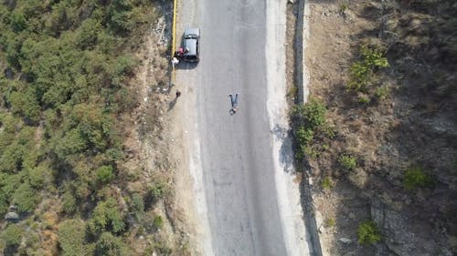 A Man Lying Down on a Road