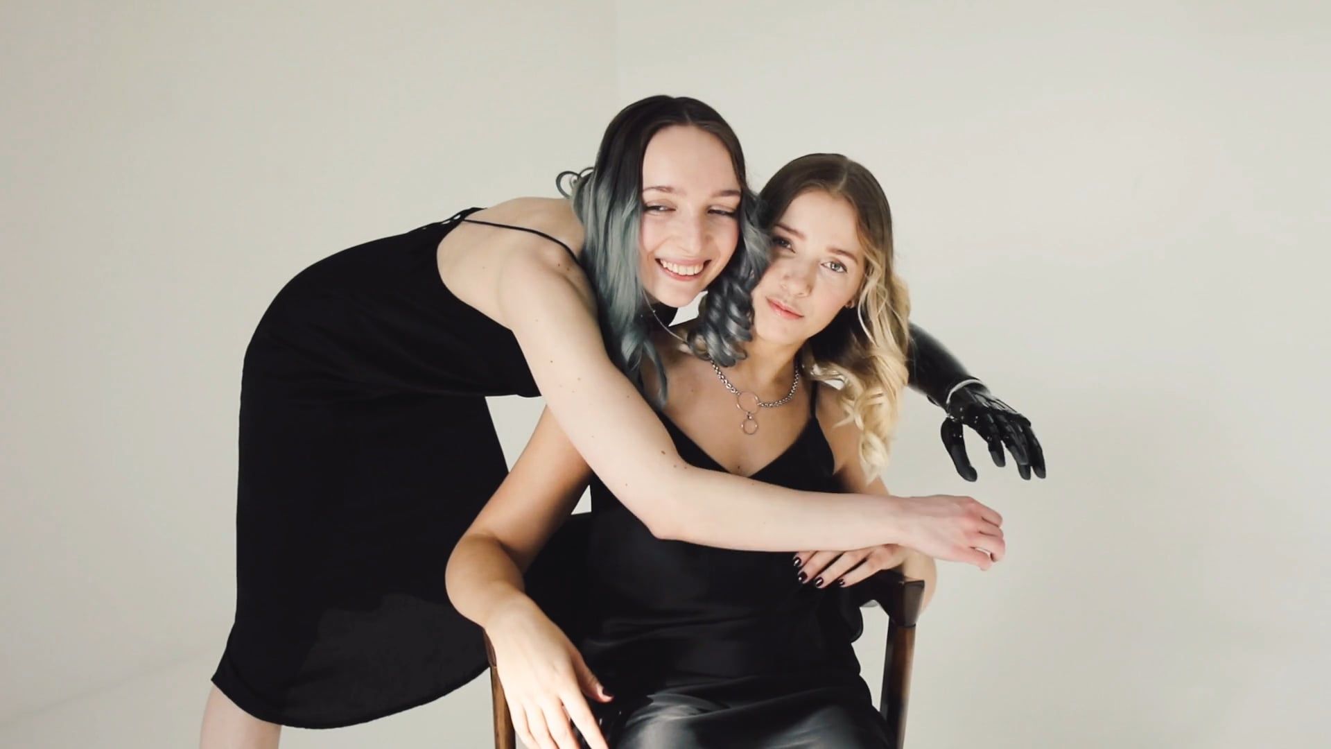 Two women in black dresses are posing for a photo Free Stock Video ...