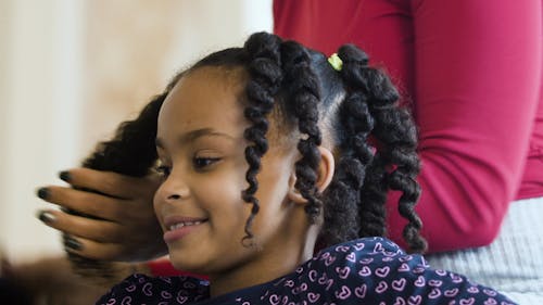 A Mother Brushing Her Daughter's Hair