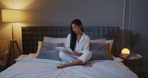 A Woman Writing in Her Diary and then Looking to the Camera