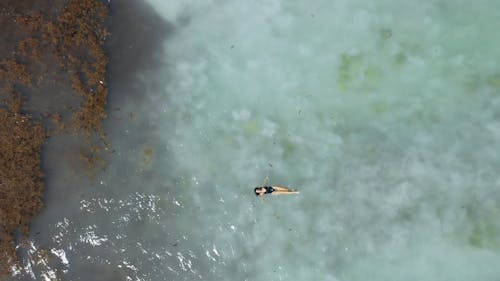 An Aerial Footage of A Woman in A Beach